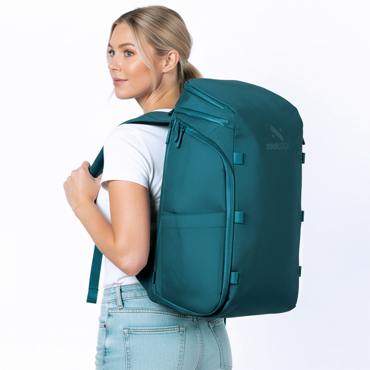 Frau mit petrolblauem Rucksack auf dem Rücken.