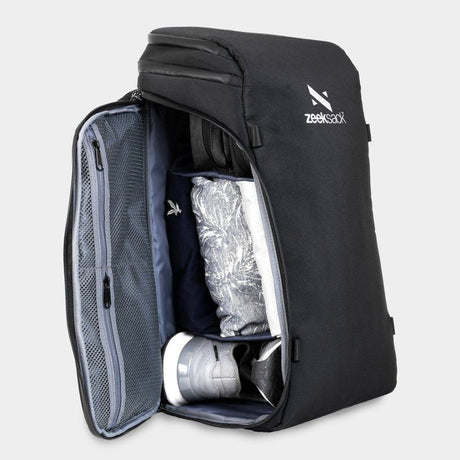 Ein schwarzer Rucksack, seitlich geöffnet und mit Schuhen und Kleidung gepackt.
