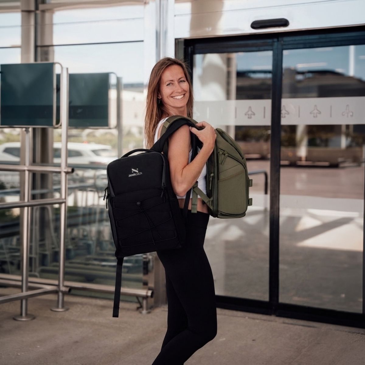 Zeeksack - Frau mit zwei The Underseat 15L in Schwarz und Ranger Green.
